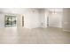 Spacious living room with tile floors and natural light from the sliding glass doors to the patio at 9807 Stephenson Dr, New Port Richey, FL 34655
