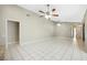 Large living room with tile flooring, ceiling fans, and neutral wall color at 9807 Stephenson Dr, New Port Richey, FL 34655