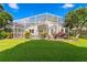 Lush backyard featuring a screened-in lanai and beautifully landscaped lawn, creating a serene retreat at 10361 Lightner Bridge Dr, Tampa, FL 33626