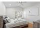 Cozy bedroom with white walls, a ceiling fan and a shuttered window at 10361 Lightner Bridge Dr, Tampa, FL 33626