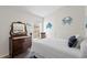 Bedroom features vintage dresser and coastal decor creating a charming, nautical theme at 10361 Lightner Bridge Dr, Tampa, FL 33626