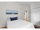 Bright bedroom with walk in closet, light walls, and wood-look flooring at 10361 Lightner Bridge Dr, Tampa, FL 33626