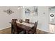 Dining room features a wooden table with seating for four, complemented by overhead lighting and decorative wall art at 10361 Lightner Bridge Dr, Tampa, FL 33626