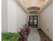 The home's entryway features elegant double doors adorned with wreaths and a welcome sign at 10361 Lightner Bridge Dr, Tampa, FL 33626
