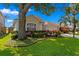 Beautiful landscaping frames this home, showcasing vibrant plants, trees and well-maintained lawn at 10361 Lightner Bridge Dr, Tampa, FL 33626