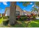 Lush greenery and colorful plants accent this home's exterior, creating a welcoming atmosphere at 10361 Lightner Bridge Dr, Tampa, FL 33626