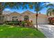 Charming home featuring a well-manicured lawn, lush landscaping, and inviting curb appeal at 10361 Lightner Bridge Dr, Tampa, FL 33626
