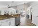 Kitchen area with granite countertops, stainless steel dishwasher, white cabinets, and view to the patio at 10361 Lightner Bridge Dr, Tampa, FL 33626