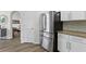 Kitchen featuring a stainless steel refrigerator, white cabinets and granite countertops at 10361 Lightner Bridge Dr, Tampa, FL 33626