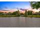 Picturesque view of the lake with homes along the shoreline in a tranquil sunset setting at 10361 Lightner Bridge Dr, Tampa, FL 33626