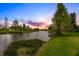 Scenic lake view at sunset surrounded by well-manicured lawns and landscaping at 10361 Lightner Bridge Dr, Tampa, FL 33626