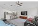 Bright living room with a ceiling fan, bar seating, and a large TV at 10361 Lightner Bridge Dr, Tampa, FL 33626