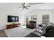 Comfortable living room featuring a large TV, cozy recliners, and bright windows at 10361 Lightner Bridge Dr, Tampa, FL 33626