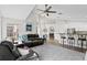 Spacious living room with vaulted ceilings, ceiling fan, bar seating, and lots of natural light at 10361 Lightner Bridge Dr, Tampa, FL 33626