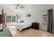 Bright main bedroom with a ceiling fan, wood floors and large windows overlooking the pool at 10361 Lightner Bridge Dr, Tampa, FL 33626