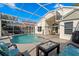 Relaxing backyard with pool, enclosed patio, and inviting seating area at 10361 Lightner Bridge Dr, Tampa, FL 33626