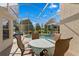 Enclosed pool area with outdoor dining, lush greenery, and serene lake views at 10361 Lightner Bridge Dr, Tampa, FL 33626