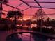 Beautiful screened pool and lanai with a stunning sunset over the water view at 10361 Lightner Bridge Dr, Tampa, FL 33626