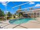 A lovely screened-in pool area overlooks a tranquil lake, perfect for relaxing or entertaining at 10361 Lightner Bridge Dr, Tampa, FL 33626