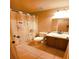 Standard bathroom features neutral tile, a shower-tub, and vanity lighting at 10819 Lake Saint Charles Blvd, Riverview, FL 33578