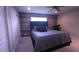 Bedroom with a decorative wood accent wall and upholstered headboard at 10819 Lake Saint Charles Blvd, Riverview, FL 33578