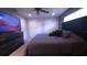 Bedroom with a ceiling fan, dresser with large TV and ample closet space at 10819 Lake Saint Charles Blvd, Riverview, FL 33578