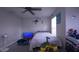 Bright bedroom with a ceiling fan, toys, and a television at 10819 Lake Saint Charles Blvd, Riverview, FL 33578