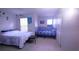 Shared bedroom space with two beds, natural light, and neutral carpet at 10819 Lake Saint Charles Blvd, Riverview, FL 33578