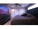Bedroom with a ceiling fan, dresser with large TV and ample closet space at 10819 Lake Saint Charles Blvd, Riverview, FL 33578