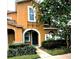 Charming two-story home featuring an arched entryway, well-manicured landscaping, and warm exterior tones at 10819 Lake Saint Charles Blvd, Riverview, FL 33578
