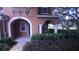 Inviting home exterior with an arched entryway, well-maintained landscaping, and cozy front porch at 10819 Lake Saint Charles Blvd, Riverview, FL 33578