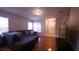 Spacious living room featuring hardwood floors, a sectional sofa, and ample natural light at 10819 Lake Saint Charles Blvd, Riverview, FL 33578