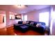 Bright living room with hardwood floors, large windows, and a comfortable sectional sofa at 10819 Lake Saint Charles Blvd, Riverview, FL 33578