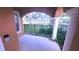 Covered porch area with decorative pillars and wrought iron railing, offering a shady outdoor space at 10819 Lake Saint Charles Blvd, Riverview, FL 33578