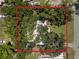 Aerial view of a home (highlighted) surrounded by lush trees, providing privacy and a natural setting at 11704 Orange Grove Ter, Riverview, FL 33569