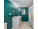 Bathroom with white tiled flooring, vanity with framed mirror, and tiled shower at 11704 Orange Grove Ter, Riverview, FL 33569