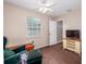 Bedroom features a ceiling fan, window with blinds, and a TV on a wooden stand at 11704 Orange Grove Ter, Riverview, FL 33569