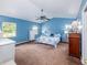 Large bedroom featuring a high ceiling, blue walls, and generous closet space, offering a comfortable retreat at 11704 Orange Grove Ter, Riverview, FL 33569