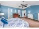 Spacious bedroom with blue walls and ensuite bathroom, providing a private and comfortable retreat at 11704 Orange Grove Ter, Riverview, FL 33569