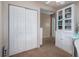 Bedroom includes an attached closet with folding doors and a large display cabinet for storage at 11704 Orange Grove Ter, Riverview, FL 33569
