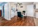 Dining room features a ceiling fan, wood laminate flooring, and a white shelving unit at 11704 Orange Grove Ter, Riverview, FL 33569