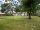 Spacious fenced in front yard with a charming single-story home at 11704 Orange Grove Ter, Riverview, FL 33569