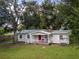 Charming single-story home with inviting front porch and lush green lawn, perfect for relaxation and outdoor enjoyment at 11704 Orange Grove Ter, Riverview, FL 33569