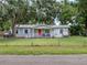 Home exterior with trees and a well manicured front lawn at 11704 Orange Grove Ter, Riverview, FL 33569