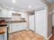 Kitchen featuring tile flooring, granite countertops, white cabinets and appliances, plus a pantry at 11704 Orange Grove Ter, Riverview, FL 33569
