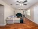 Cozy living room with wood-look floors, ceiling fans, and comfortable seating, perfect for relaxing and entertaining at 11704 Orange Grove Ter, Riverview, FL 33569