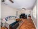 Spacious living room with hardwood floors, ceiling fans, and ample space for relaxing and entertaining guests at 11704 Orange Grove Ter, Riverview, FL 33569