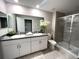 The bathroom has double sinks, granite countertops, and a glass-enclosed shower, and neutral walls at 11847 Dumaine Valley Rd, Riverview, FL 33579