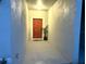 Inviting doorway featuring a bold red door, complimented with simple decorations at 11847 Dumaine Valley Rd, Riverview, FL 33579