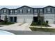 Attractive townhouse featuring a two-car garage, complemented by a well-maintained lawn and simple landscaping at 11847 Dumaine Valley Rd, Riverview, FL 33579